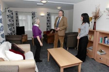 Project manager Janet Thomas, left, and and support worker Claire Sumner talk with Julian Brazier MP in the women's refuge lounge