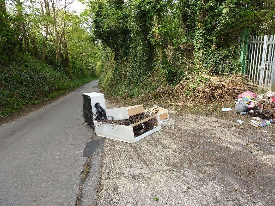 Remains of a bed hang in the road, causing a potential hazard to motorists.