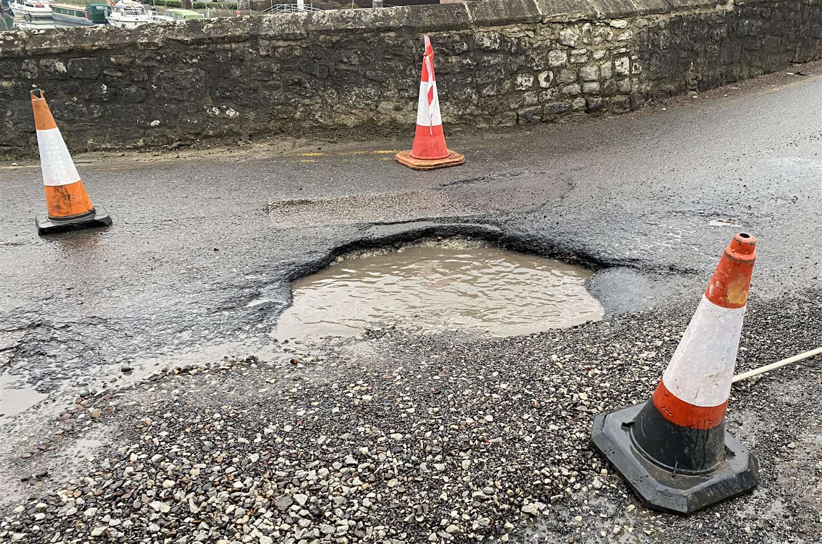Huge pothole just before the East Farleigh Bridge near Barming, Maidstone