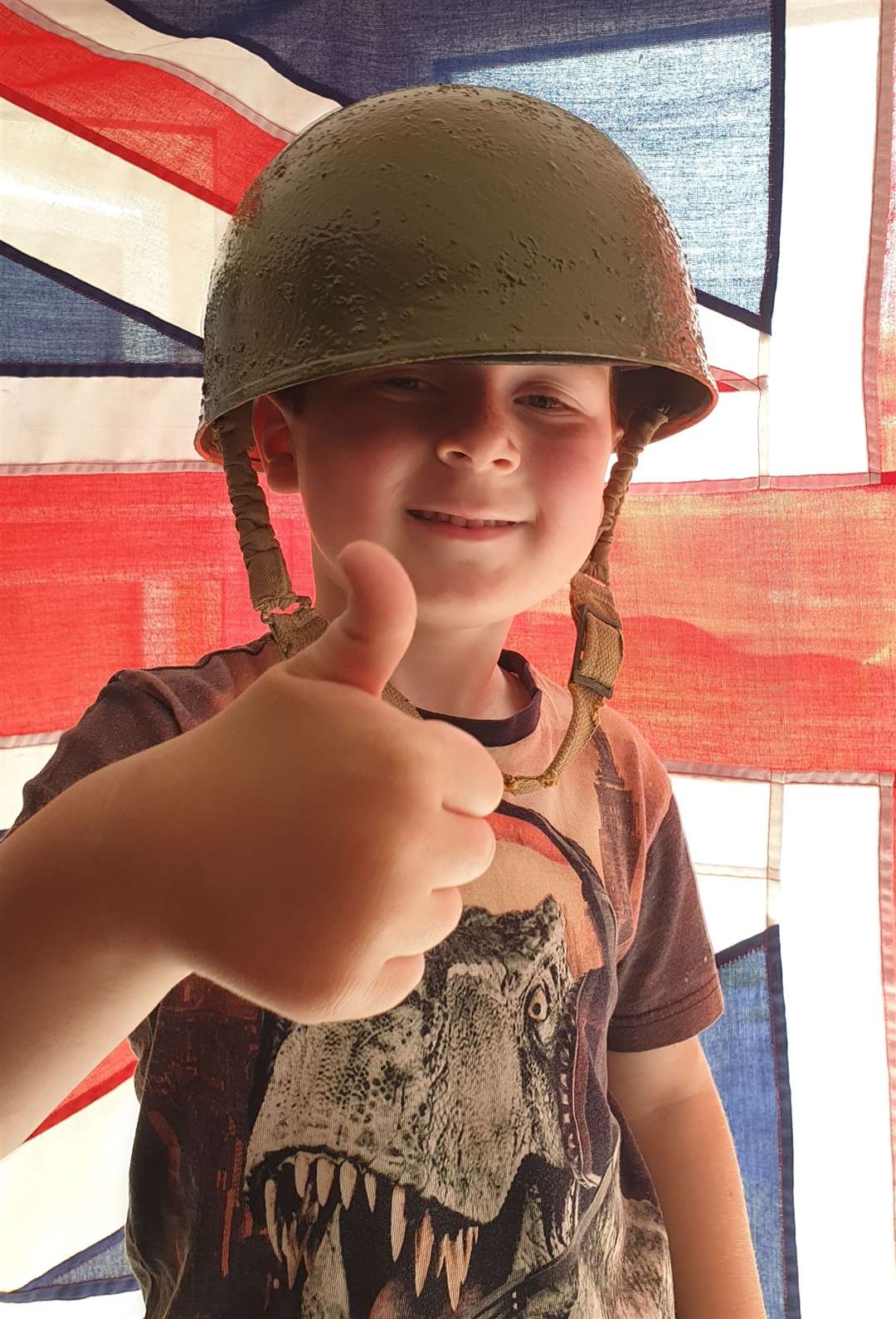Teddie Bloxham, a young history fan, decorated his house and donned a military helmet for VE Day 75