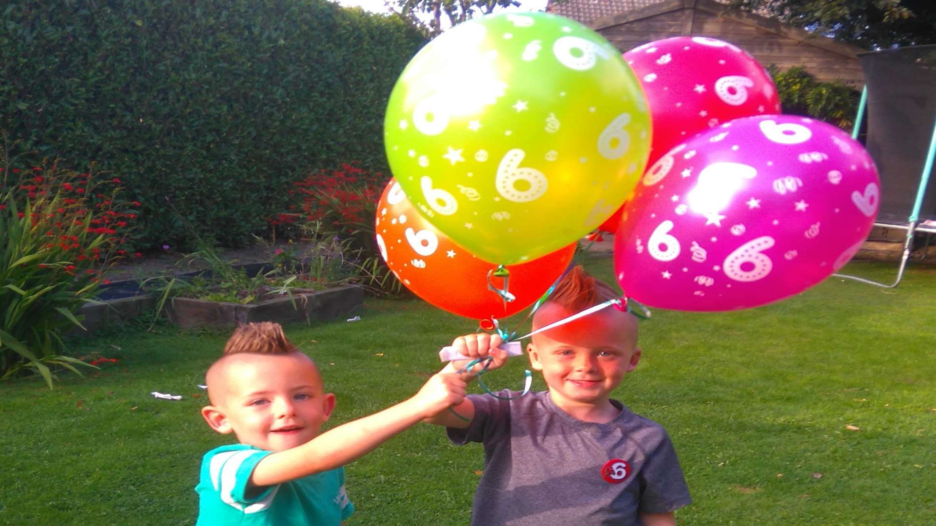 Connor and Danny letting off the balloons in their back garden