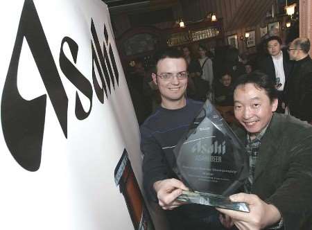 CHAMPION: Asahi Beer Europe MD Tad Nakai presents the Asahi Pure Logic Sudoku championship trophy to David McCrea