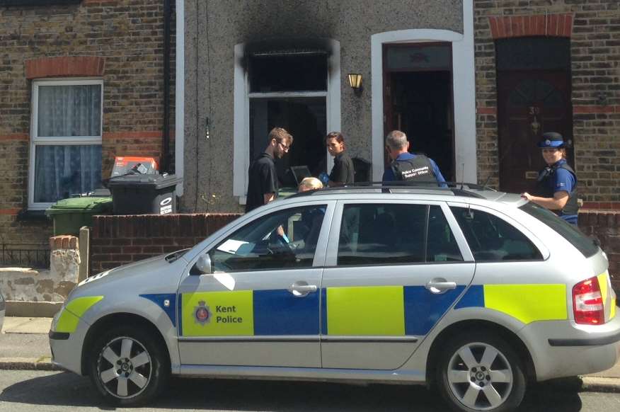 Police at a terraced property in Howard Road, Dartford, after a blaze