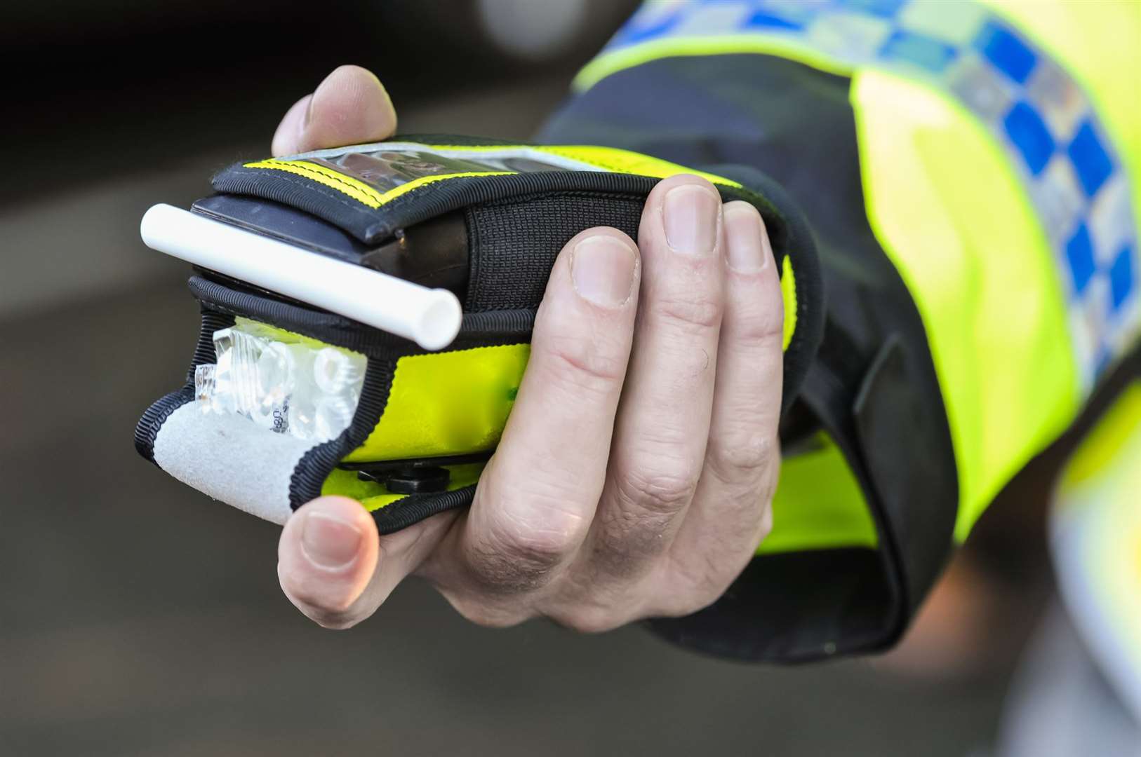 A police officer holds a roadside breathalyser. Picture: iStock
