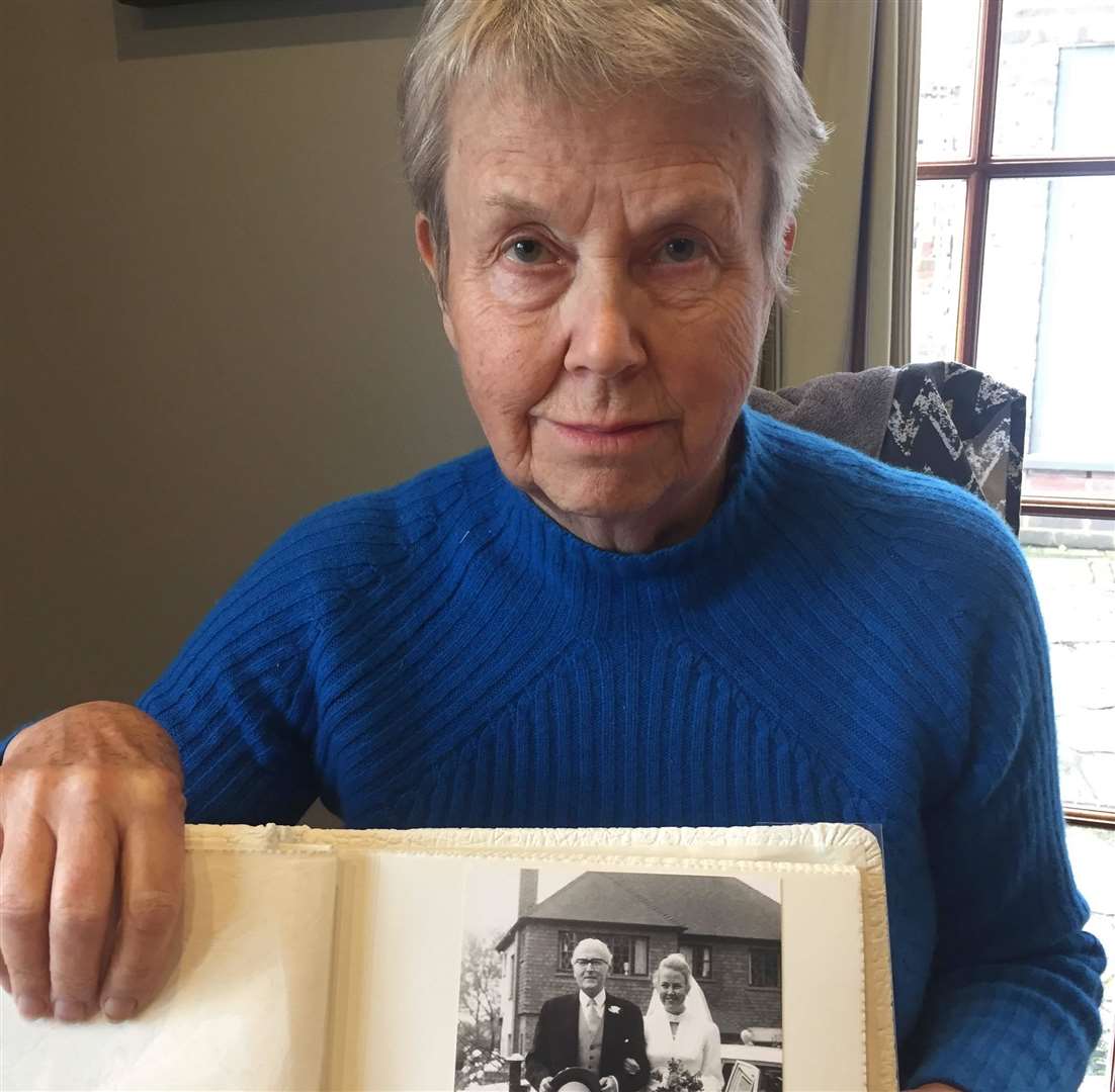 Suzanne with a picture of her mother and father