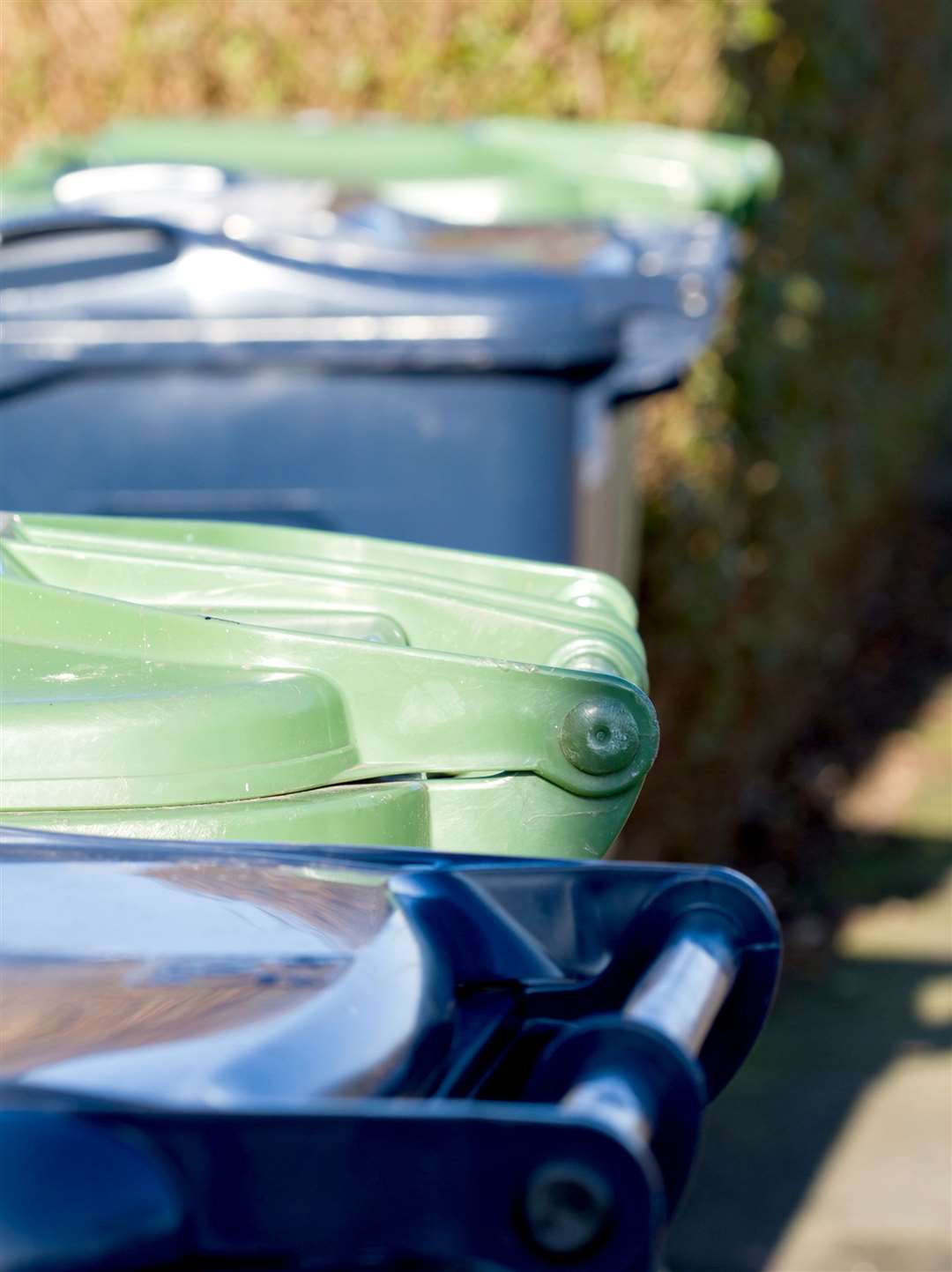 Line of wheelie bins waiting to be emptied. Stock picture
