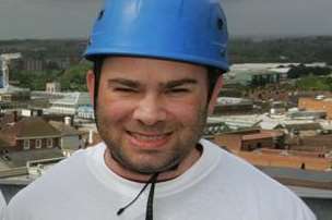 Toby Whitesman doing a charity abseil off Charter House in Ashford
