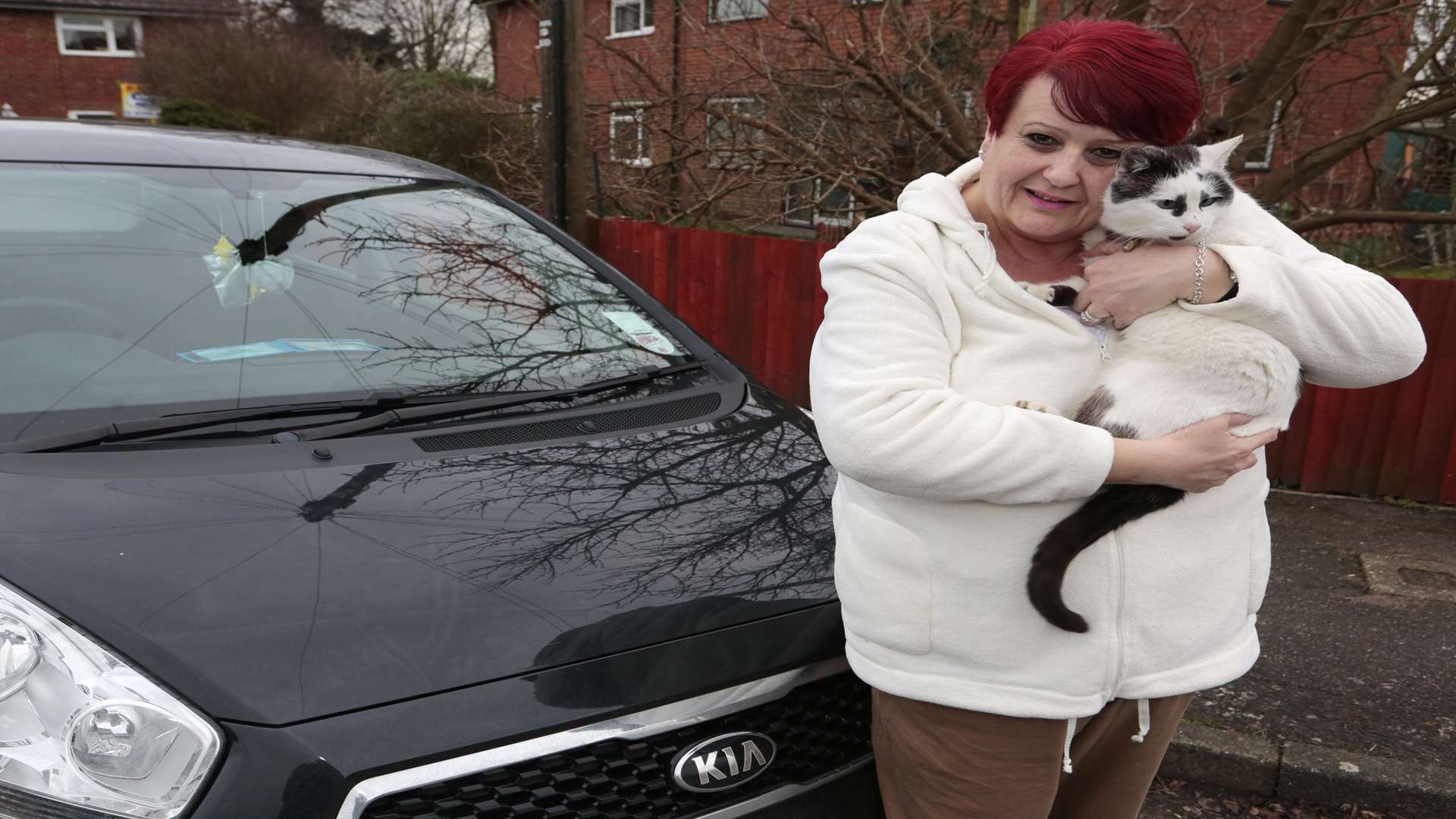 Jane Butcher with Timmy who got stuck under her bonnet. Picture: Martin Apps