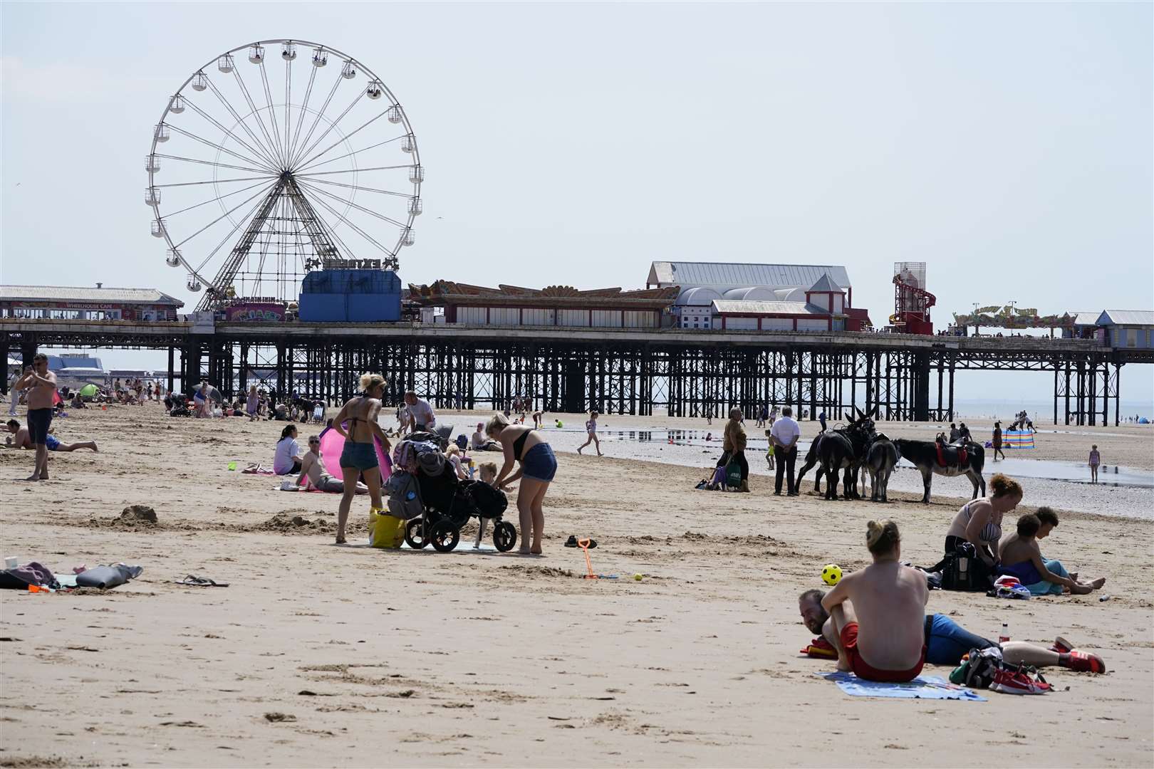 People enjoying the hot weather on Blackpool beach (Peter Byrne/PA)
