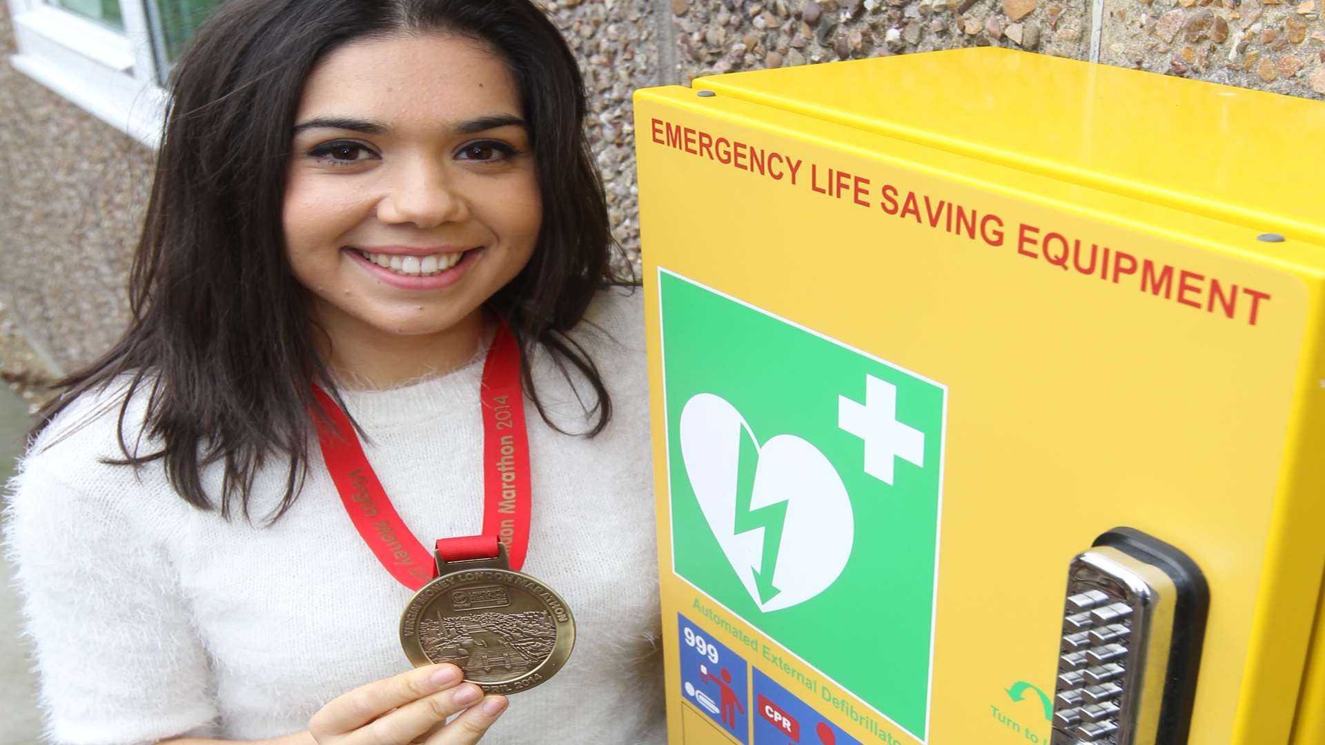 Georgina Nicolettos with one of three defibrillators she has funded