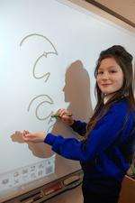 Millie Thompson-Dwyer,10, writes her name in shorthand during a lesson about journalism