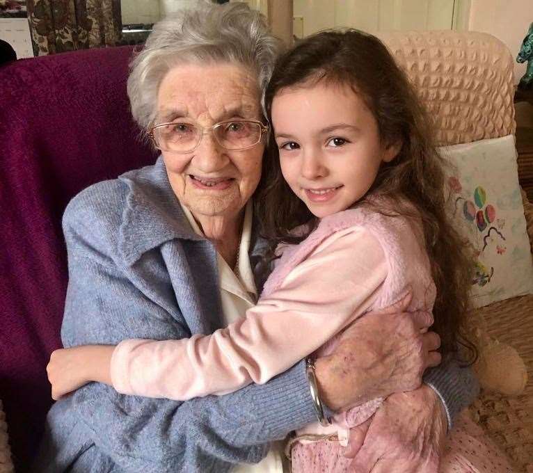 Sophia, seven, gives birthday girl Hilda a hug