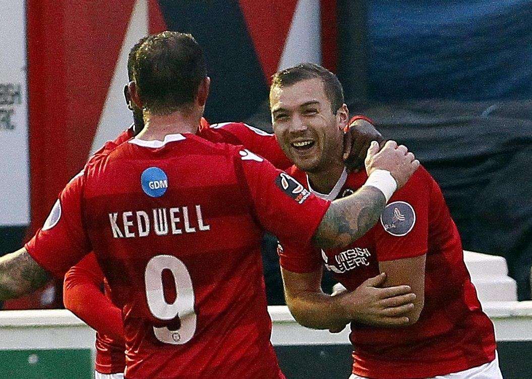 Michael Cheek celebrates one of his goals with Danny Kedwell Picture: Sean Aidan