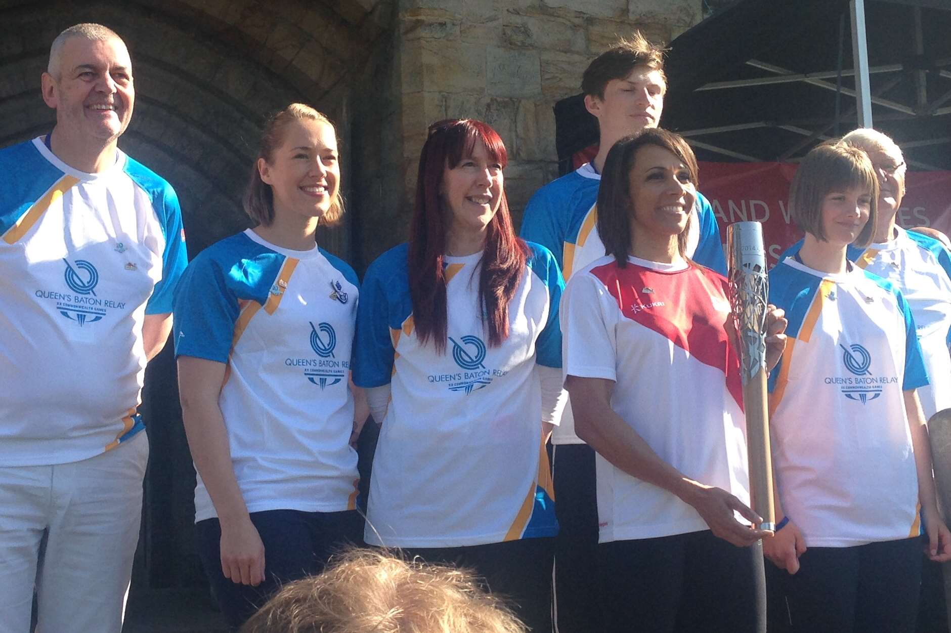 Baton bearers line up with the baton, including Dame Kelly Holmes