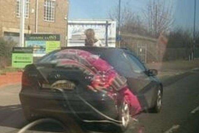 This child caused alarm when she was caught on camera standing through the sunroof of a fast-moving car in Medway