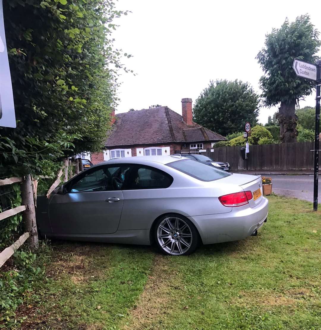 A car crashed into a front garden at the roundabout between The Street, Cobham and Cobhambury Road earlier this month. Photo: @CobhamTrafficDiary