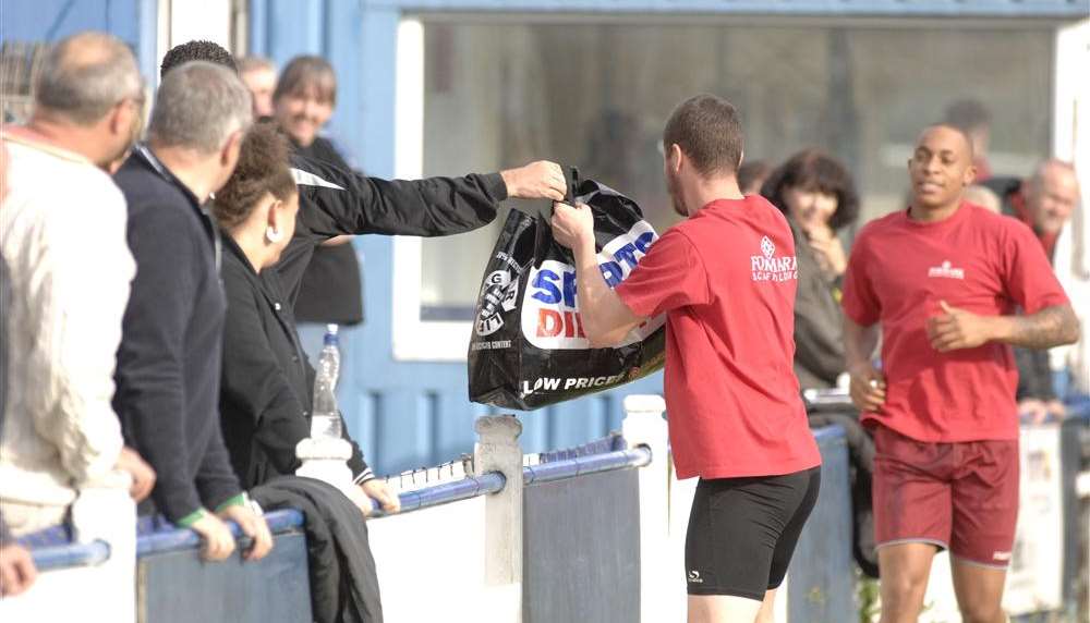 A bag of kit is handed to the Whyteleafe team at Winch's Field in the hope of starting the game with Canterbury on Saturday. Picture: Chris Davey