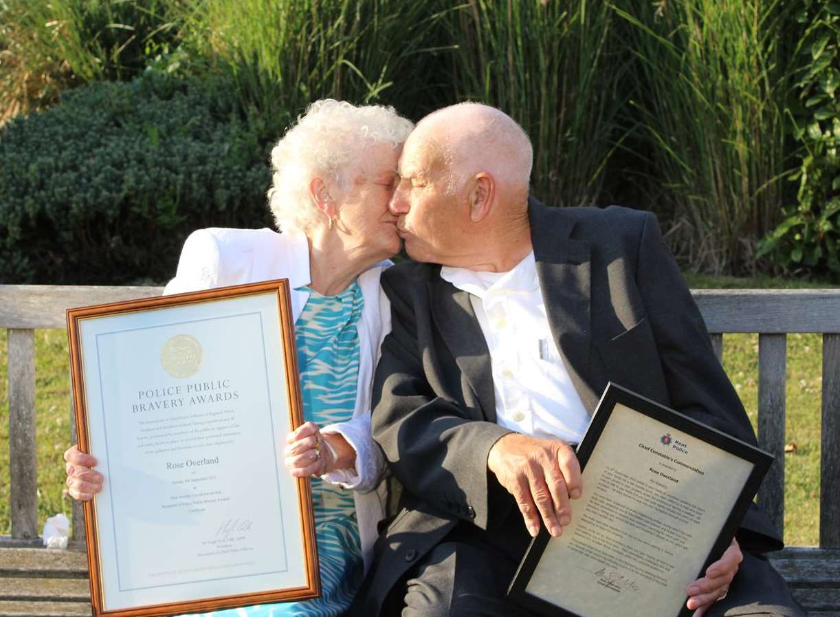 Rose Overland and her husband Derek share a kiss after the 85-year-old was presented with her award and merit for bravery