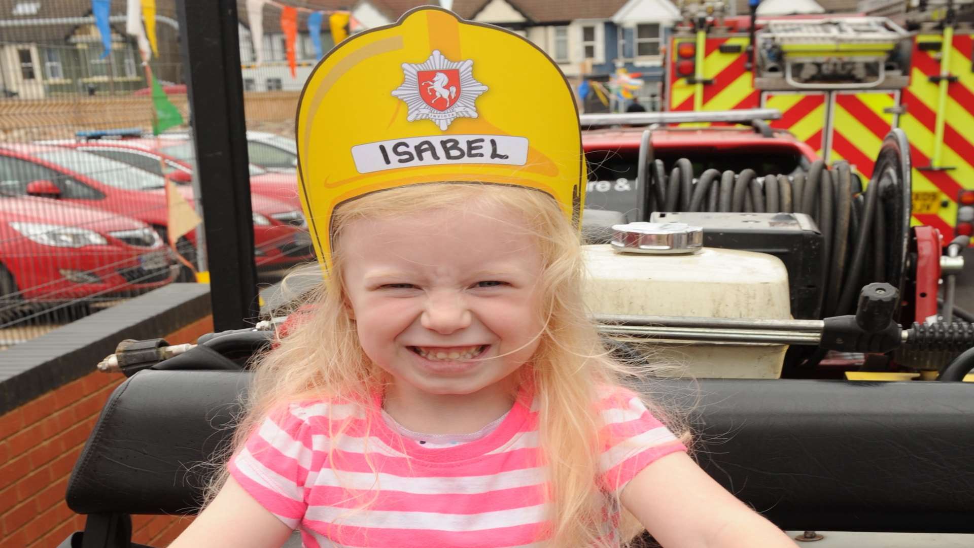 Isabel, four, takes a close-up view of a fire engine