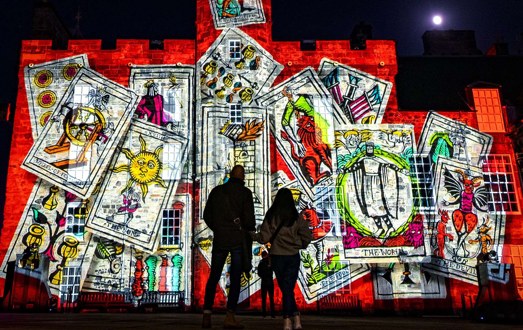 A couple view the projections in Crown Square at the Castle of Light: Magic and Mystery event at Edinburgh Castle as the after-dark spectacle returns to transform the city’s skyline (Jane Barlow/PA)