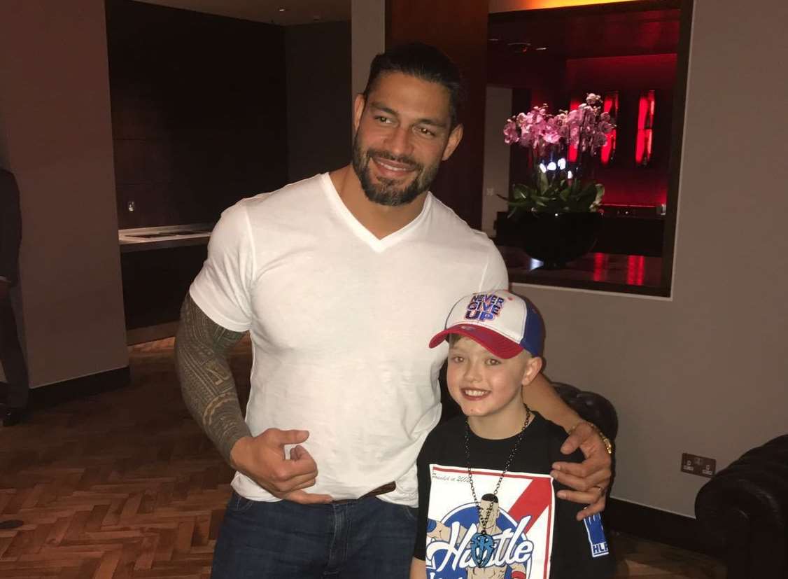 Tommie with Roman Reigns.