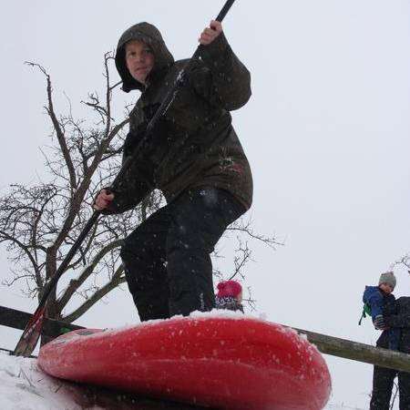 Parish councillor James Hunt tries paddle-boarding in the snow in Iwade