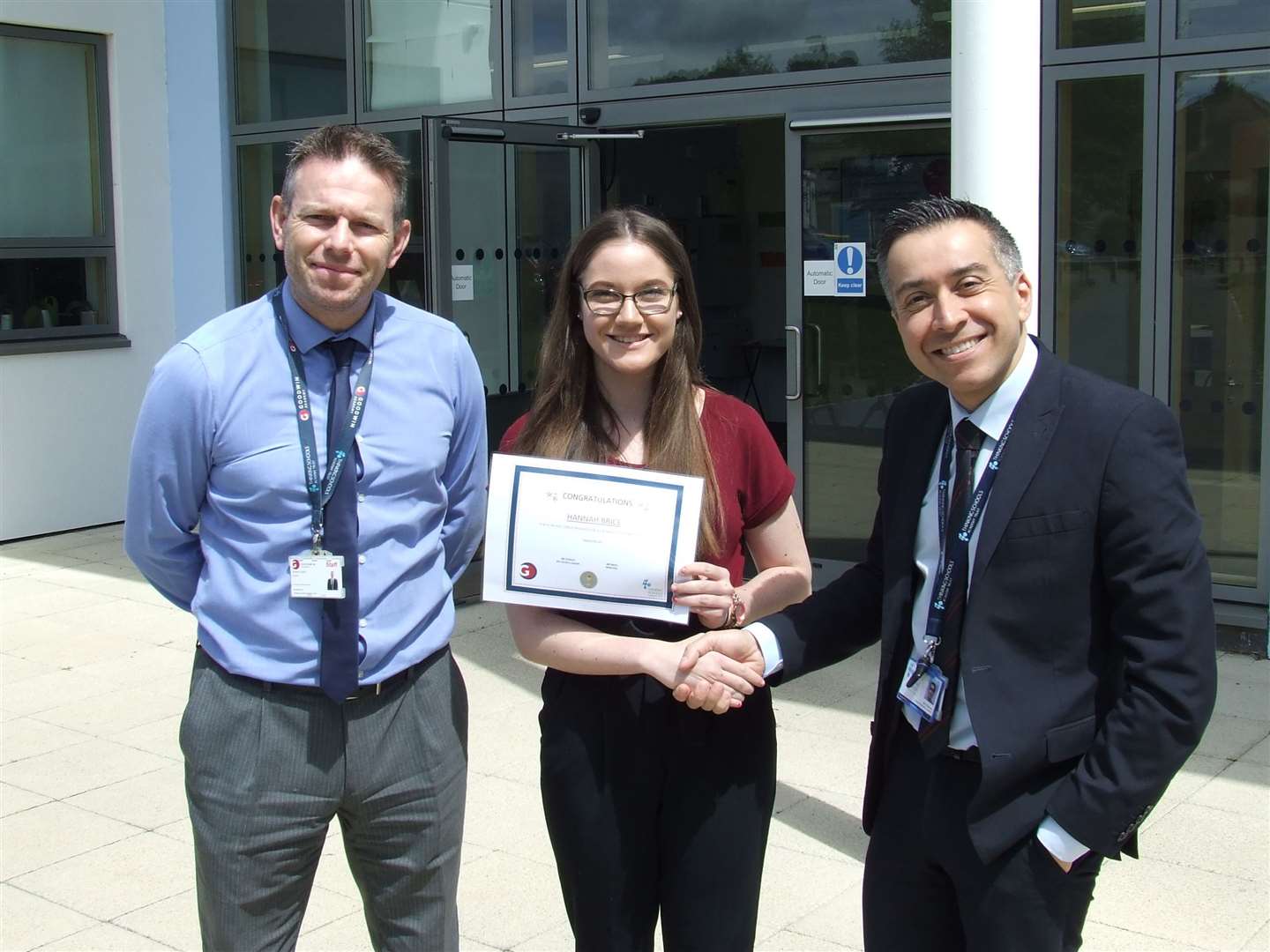 Hannah Brice is congratulated by TSAT director Gwynn Bassan (right) and Goodwin Academy principal Simon Smith (left) for her 100% attendance