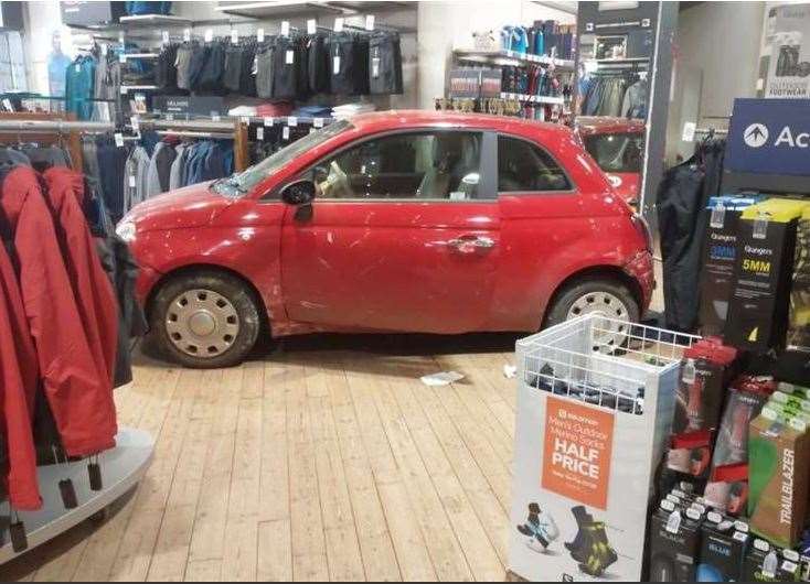 A Fiat 500 ended up inside Blacks store after crashing through the shop-front. Picture Ollie Brock