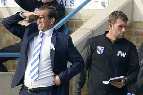 Gills boss Justin Edinburgh and goalkeeping coach Jimmy Walker on the touchline against Oldham Picture: Barry Goodwin