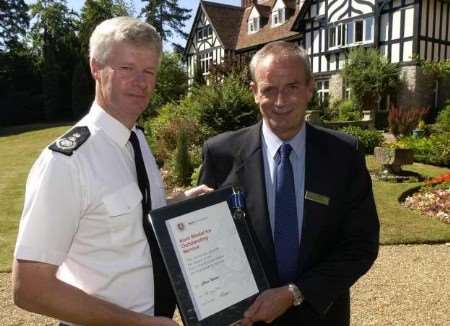 Chris Nelson, right, receiving an award from chief fire officer Peter Coombs in 2003