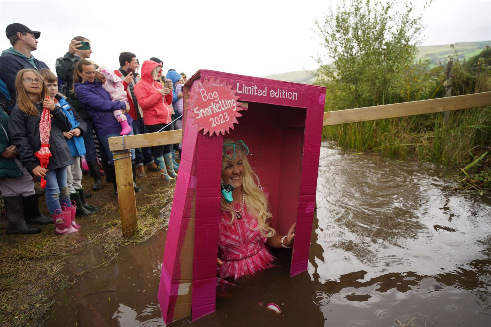 A woman dressed as Barbie, the doll from one of the year’s biggest films, takes part in the Rude Health World Bog Snorkelling Championships at Waen Rhydd peat bog in Llanwrtyd Wells, Wales, in August (PA)