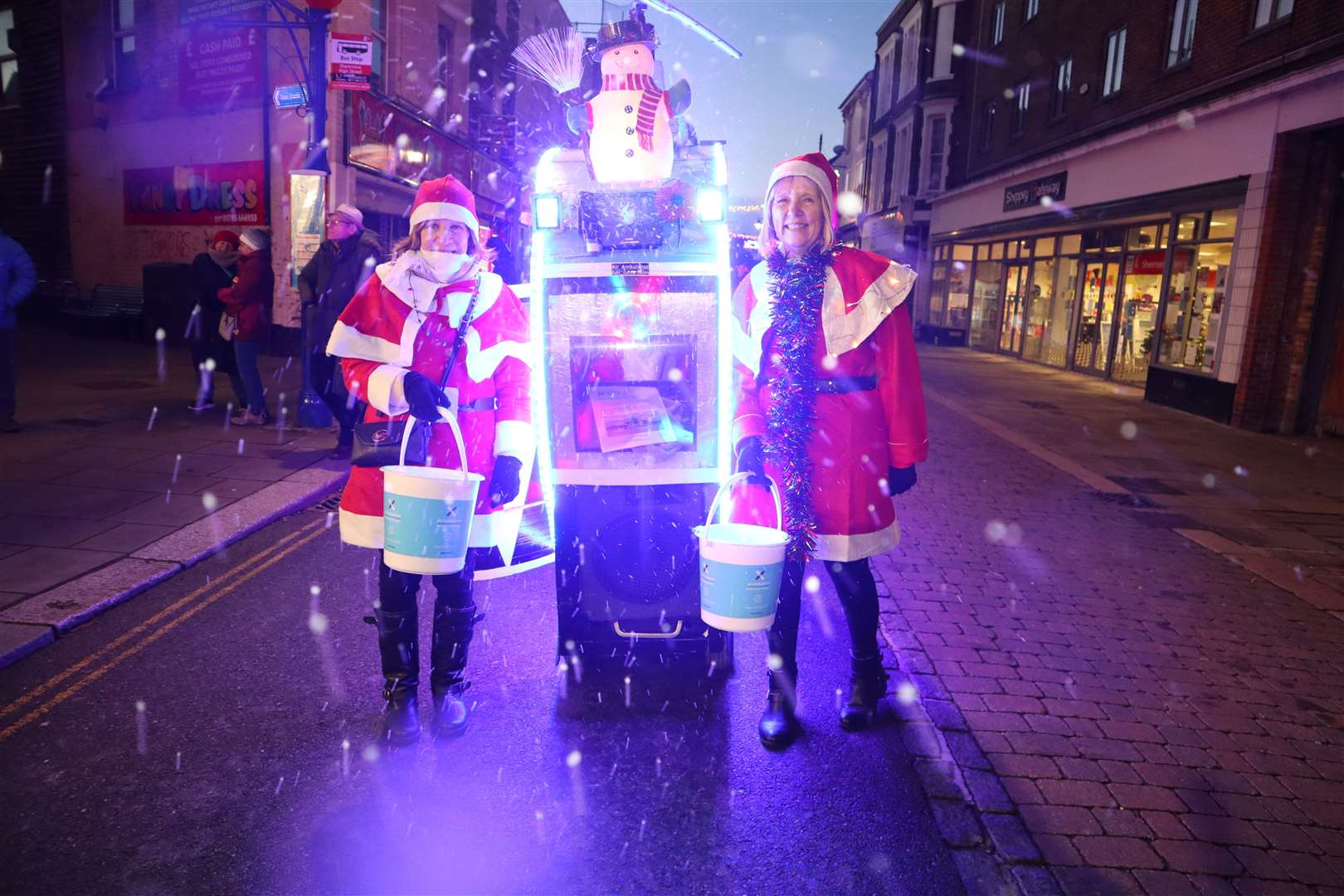 Tim Bell's snow-spewing musical illuminated helicopter and his two Santa helpers proved a big hit with the crowd