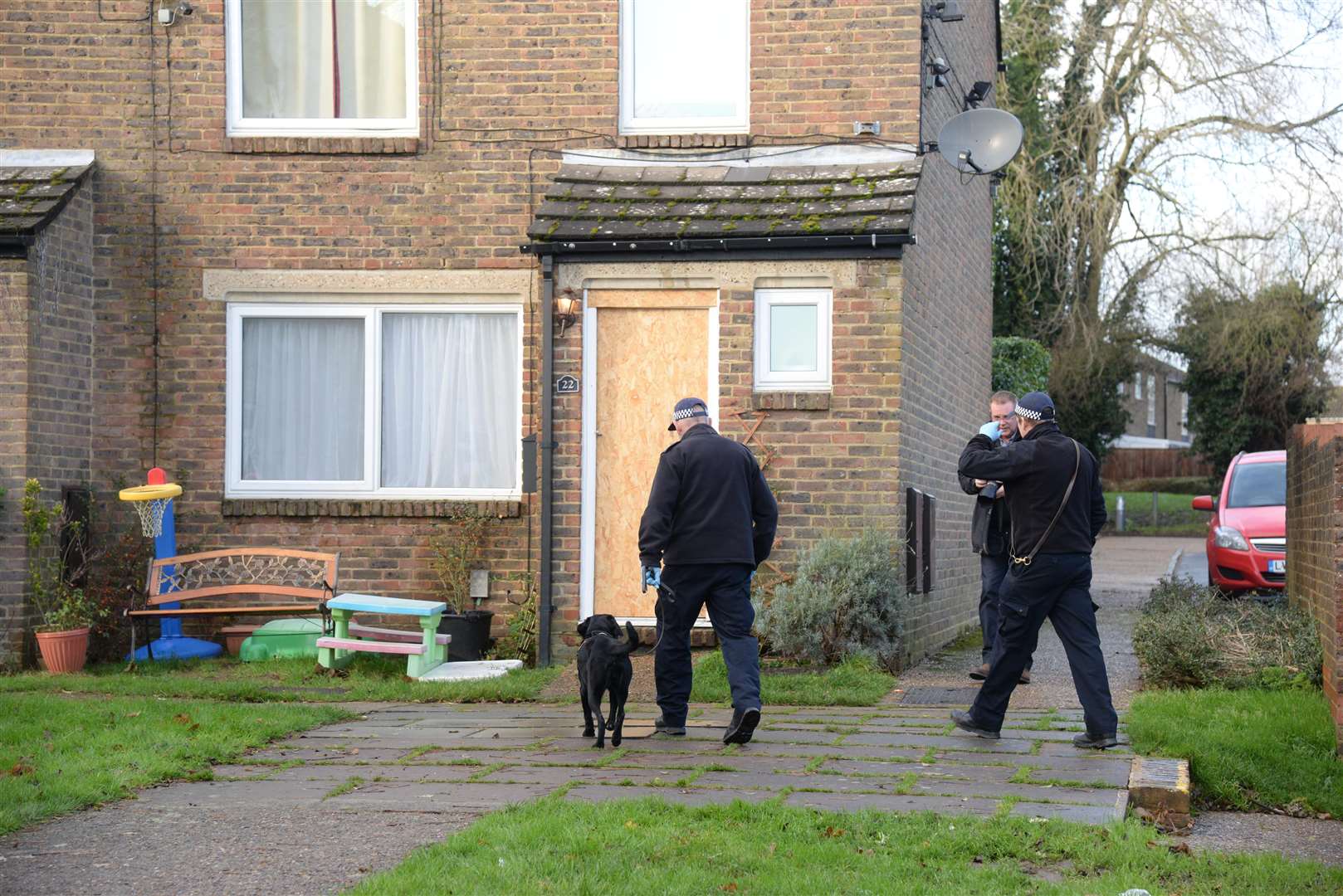 A police dog and handler going into the home in Bazes Shaw, New Ash Green, Picture: Chris Davey. (6154791)