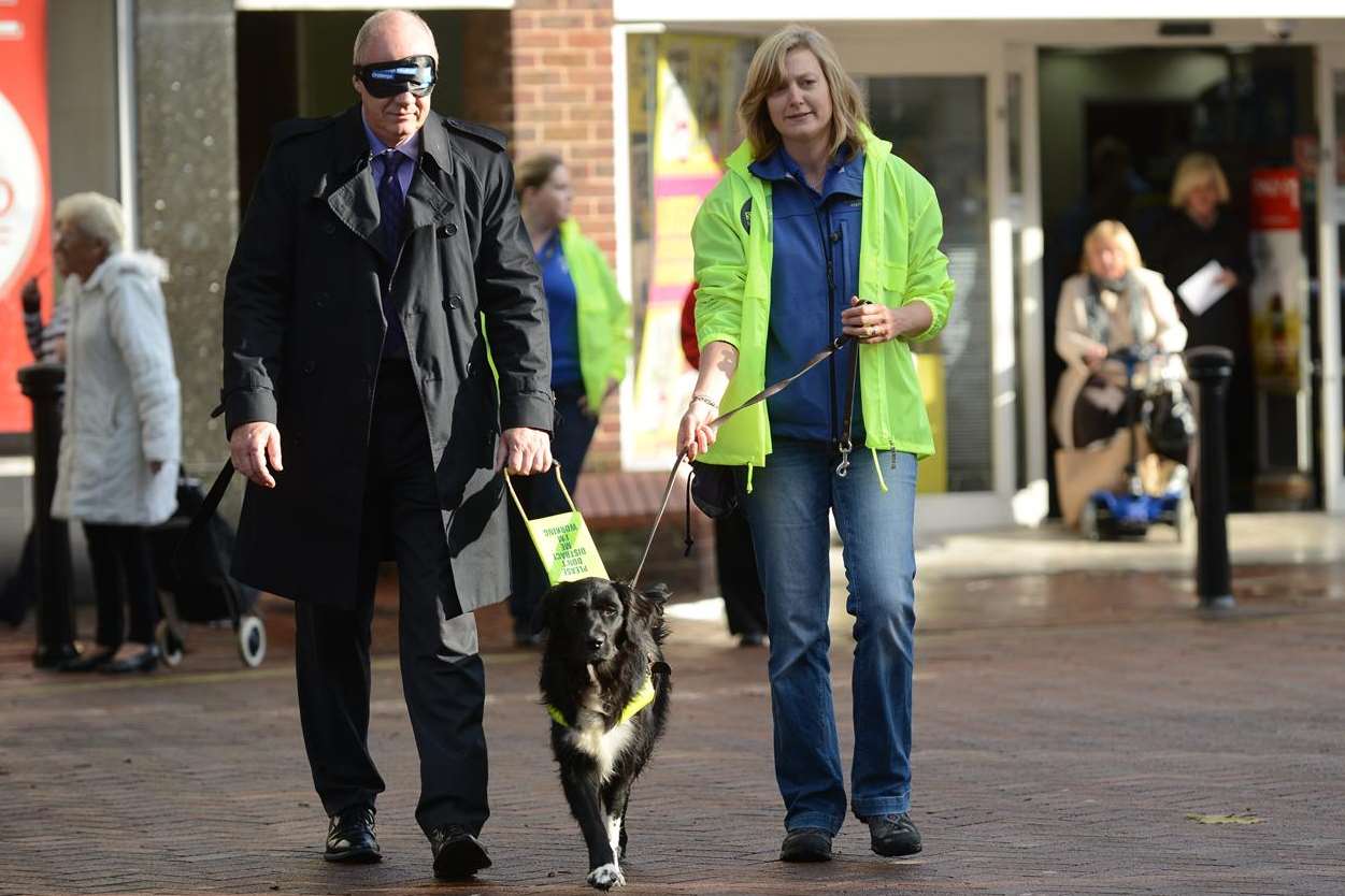 MP Damian Green with Sabine Chapman and trainee guide dog Rosie. Picture: Gary Browne