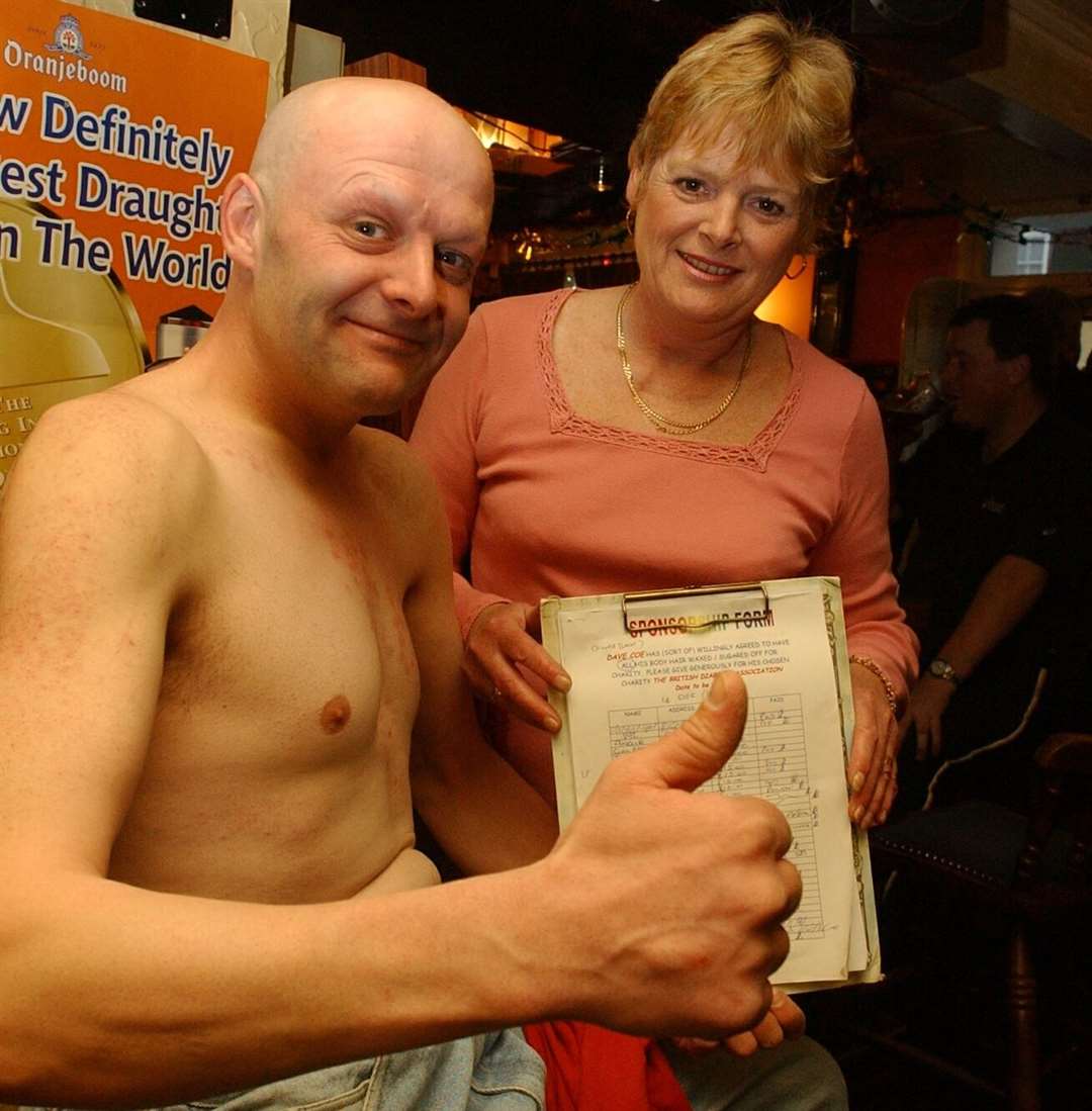 In Deal in December 2002, Saracen's Head customer Dave Coe had all of his body hair - from the top of of his head and including eyebrows and between his toes - removed for charity. He is pictured with landlady Pam Canale. The pub in Alfred Square is still going today. Picture: Mike Waterman