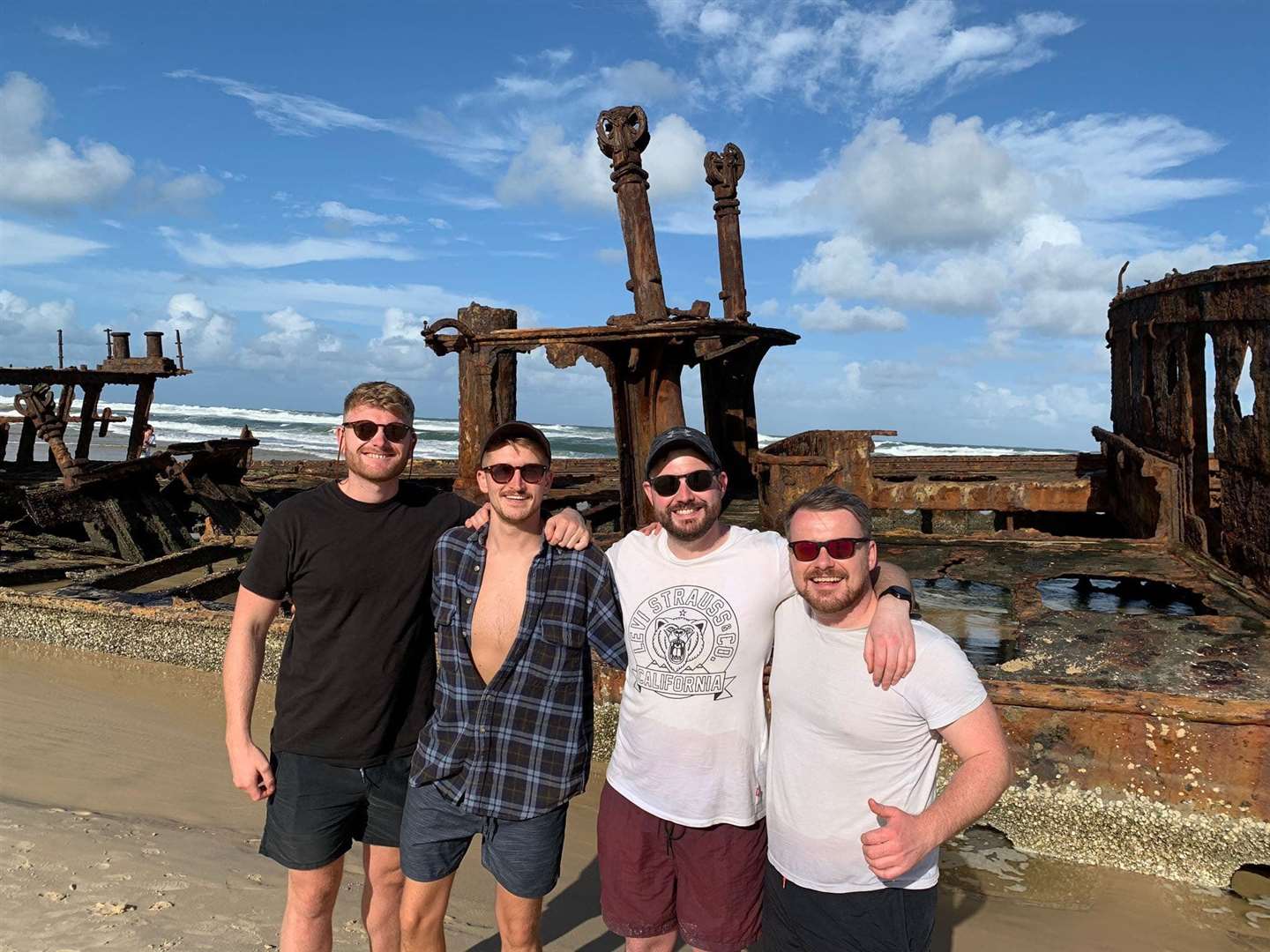 Liam Minnock (second from right) was due to return to Britain after a two-week holiday in Australia today