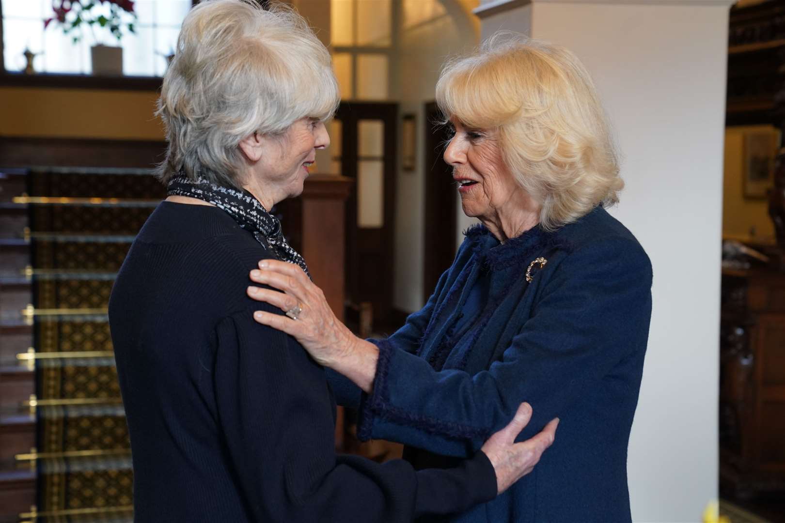 Queen Camilla (right) meets Diana Parkes CBE who founded Joanna Simpson Foundation, during a visit to Government House, in Onchan, Isle of Man (Owen Humphreys/PA)