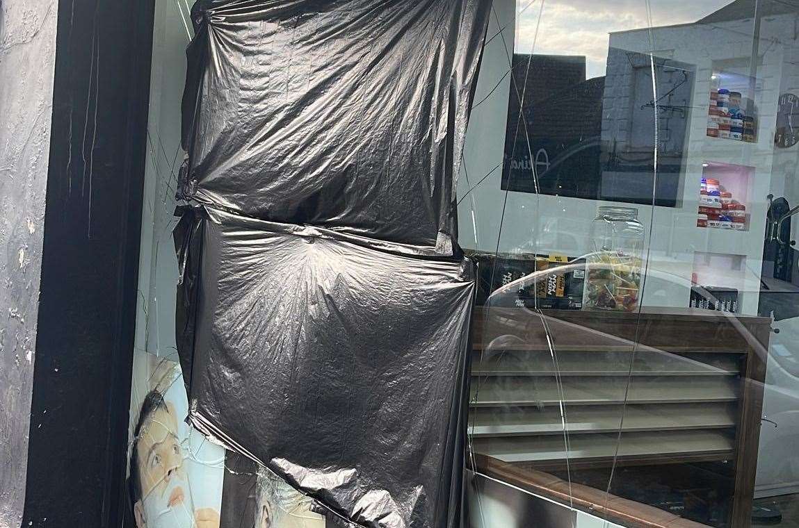 The smashed window at Jacob's Barbers is covered by a bin bag. Picture: Sirwah Rashedi