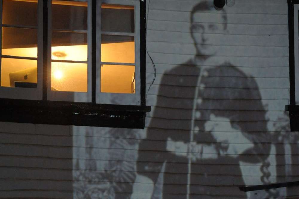 The projection of Oliver Page on the side of The Vine