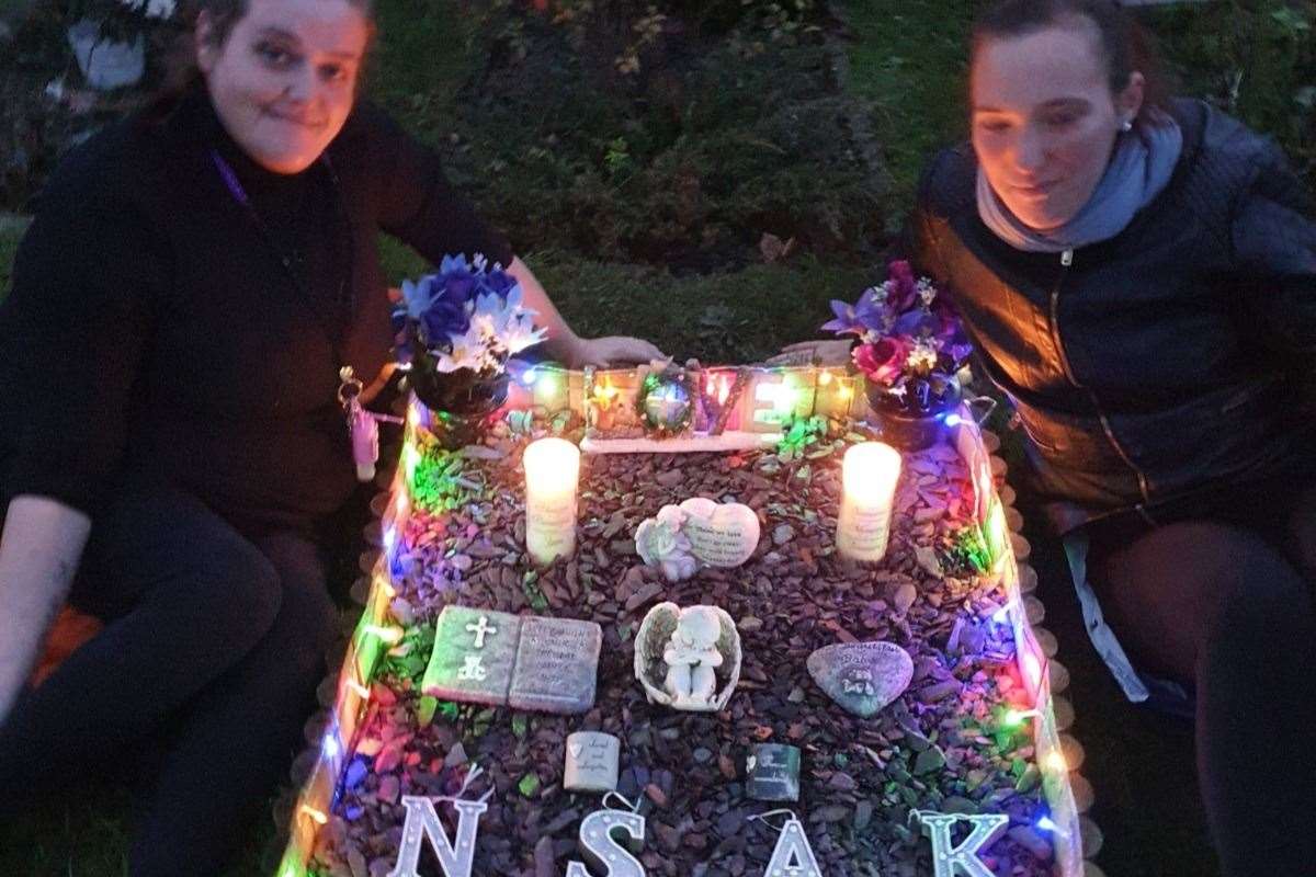 Katrina (left) and Jade at the grave containing their four babies