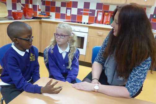 Children involved with Buster's Book Club at Archbishop Courtenay Primary School, Maidstone discuss books they have read.