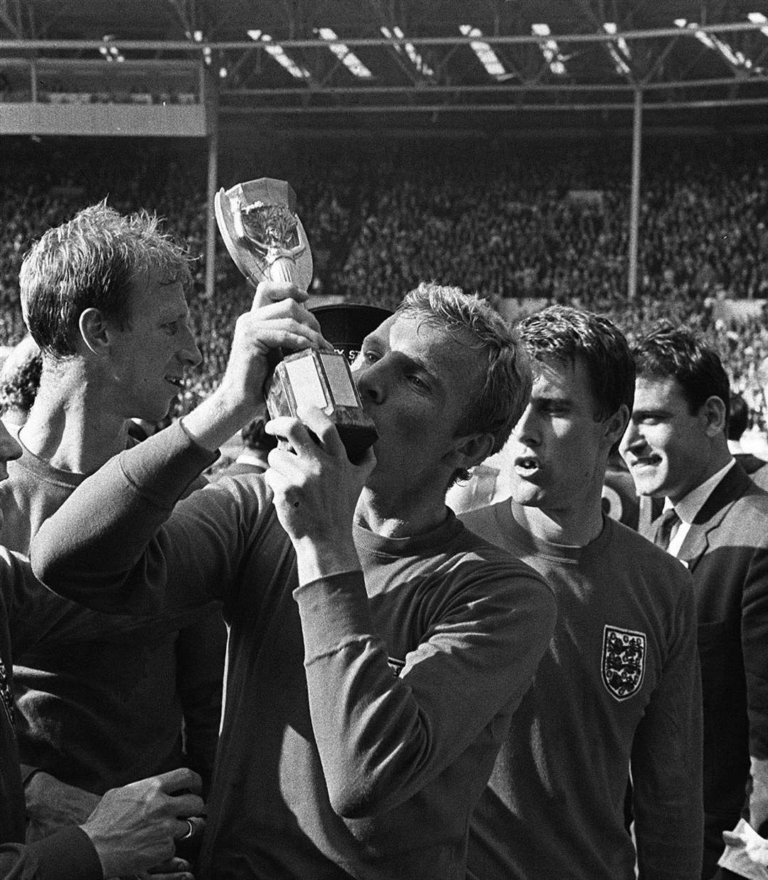 Bobby Moore planting an enthusiastic kiss on the World Cup trophy after England's historic victory over West Germany in the World Cup in1966. Picture: PA