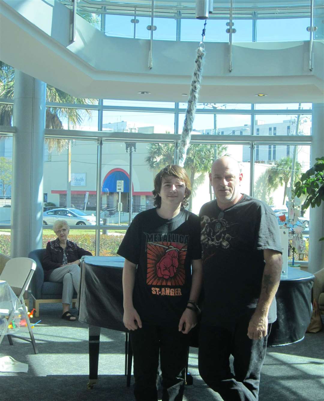 Cameron Norman aged 13 with father Stuart ringing the end of treatment bell at the specialist centre in Florida