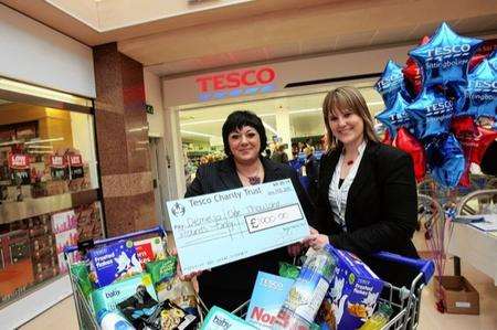 To celebrate the opening of the new Tesco Metro store at the Forum Shopping Centre, manager Anna Webb presents a Â£1,000 cheque to Laura Smyth, community fundraiser for Demelza Hospice Care for Children