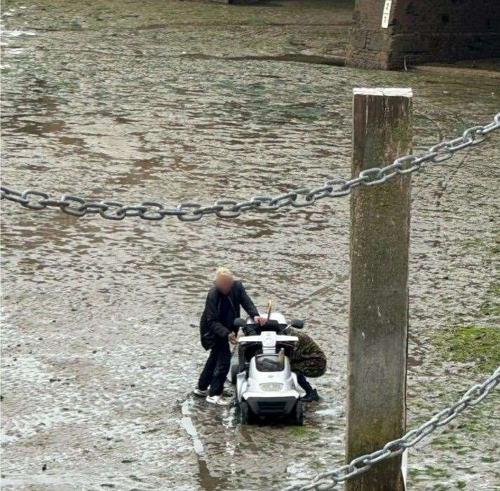 The tide was coming in as two people struggled with a mobility scooter in Folkestone harbour. Image: Sandy’s fish and chips