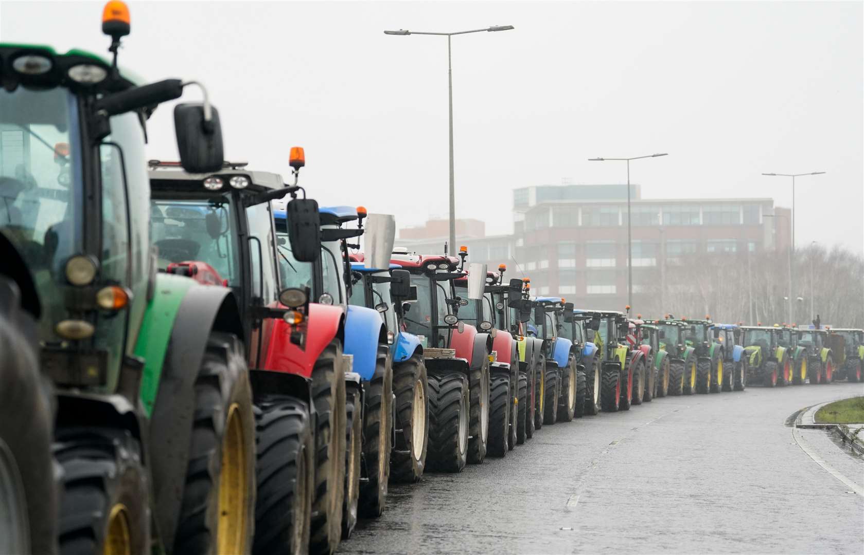 A line of tractors parked along a road leading to Cardiff Bay after South Wales Police previously asked those attending not to bring the vehicles (Andrew Matthews/PA)