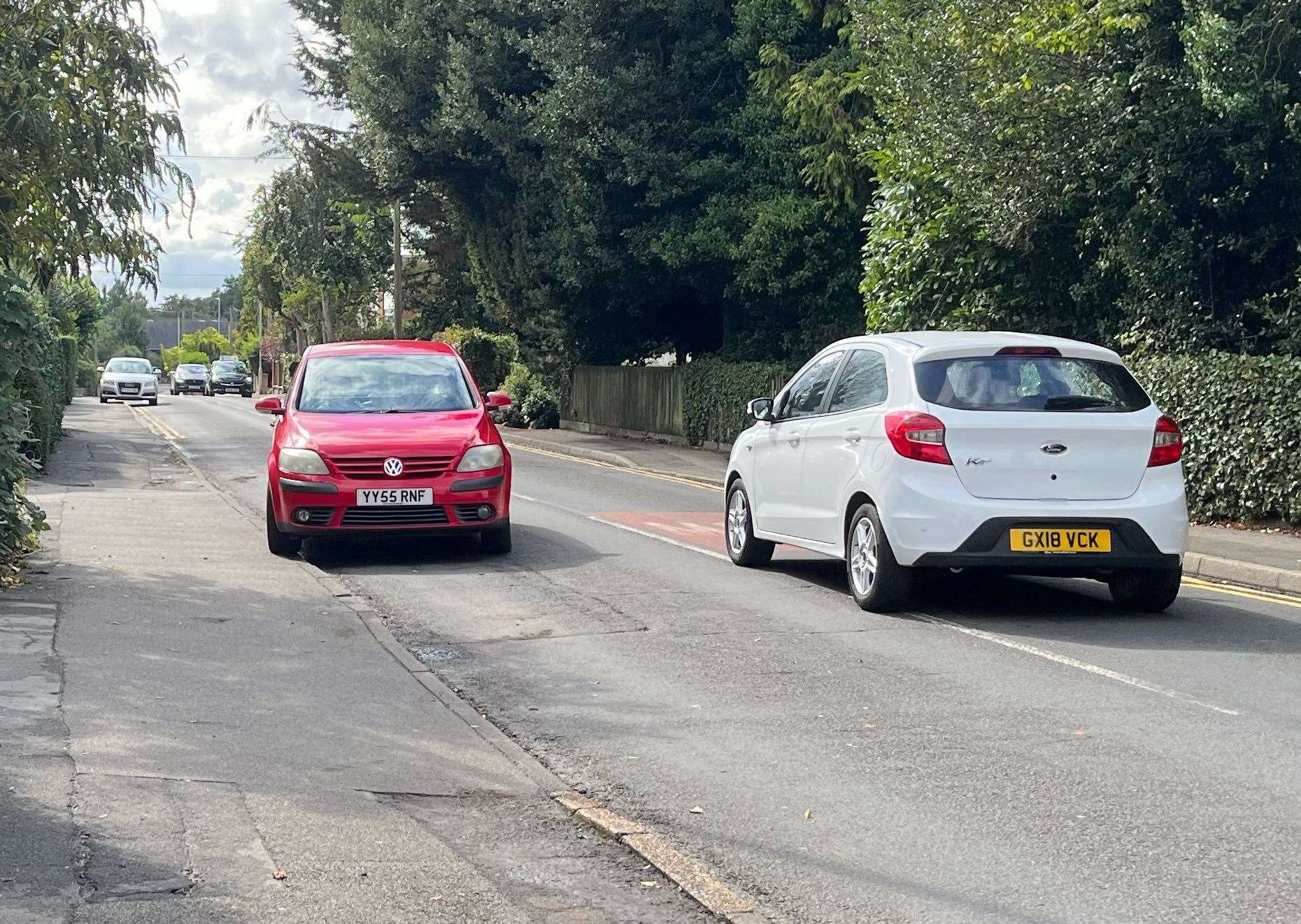 Drivers have to go on the wrong side of the road to avoid the cars