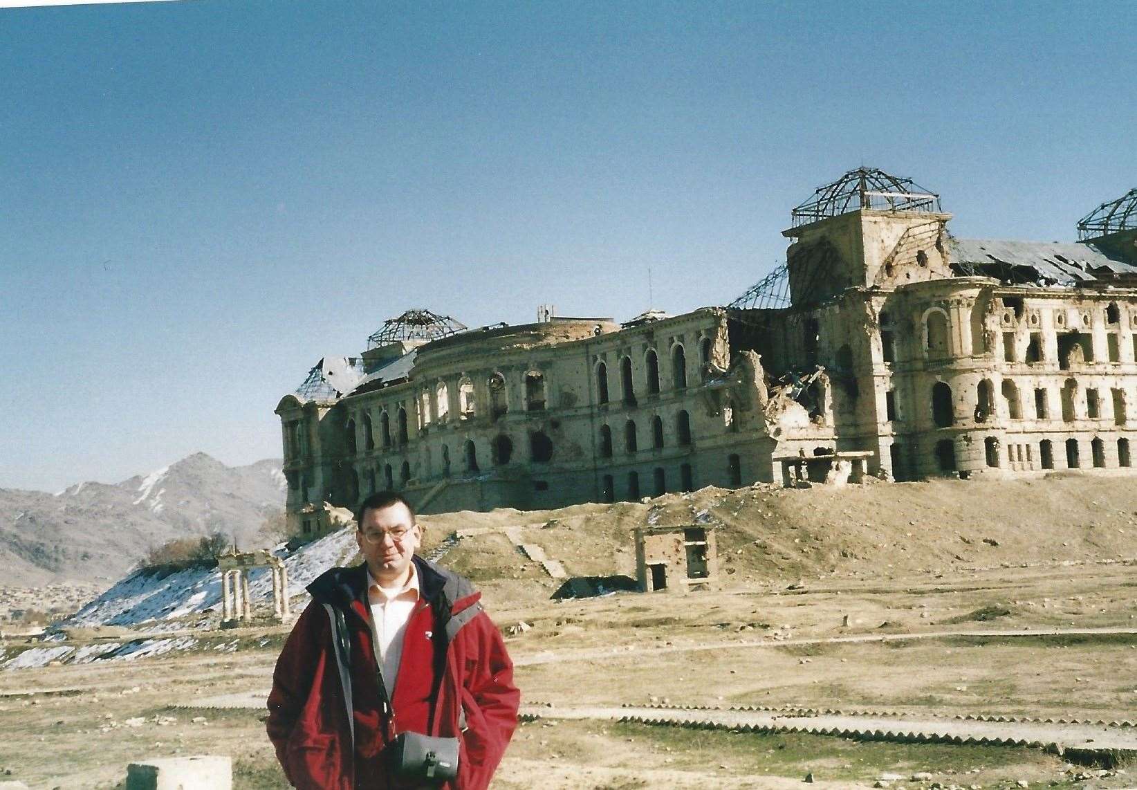 Paul Harper in front of the Daral Aman Palace near the country's National Assembly Building