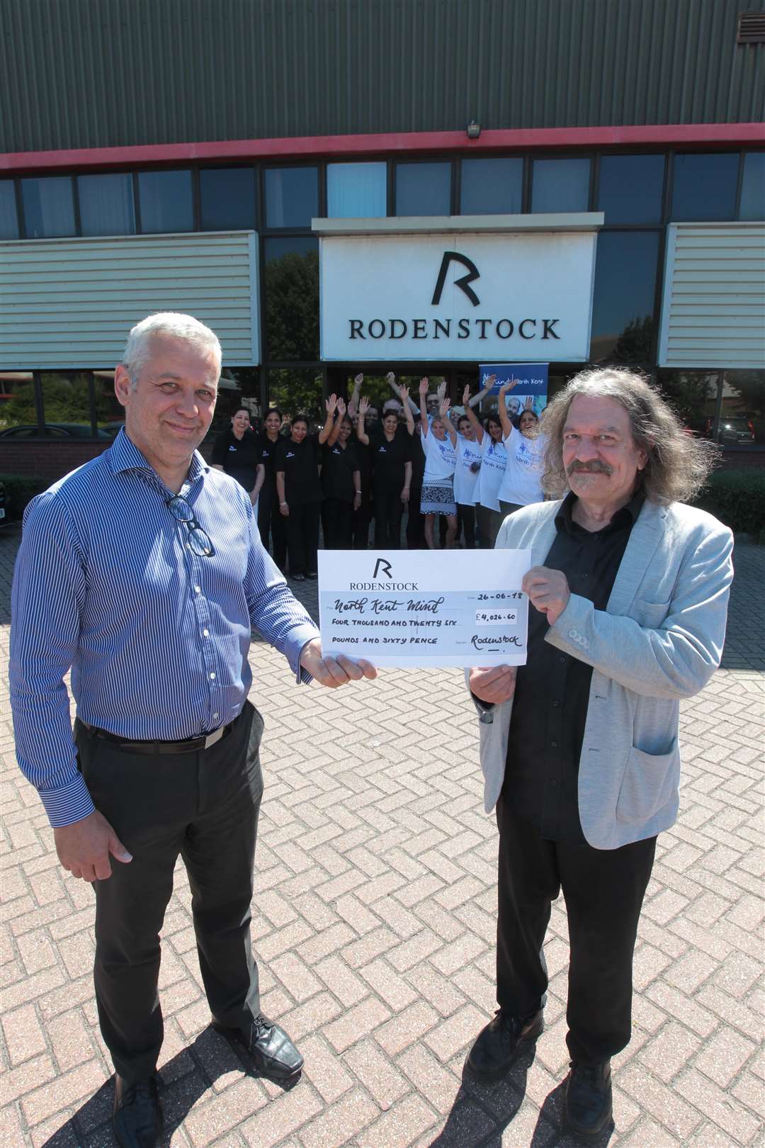 From left, Steve Beaty, ICT Manager hands over a cheque for Â£4026, to Justin Bateman Chief Executive of North Kent MIND, on behalf of the Rodenstock employees, who raised the money from walking from the company premises six plus miles to the Dartford Temple. Picture by: John Westhrop. (2747185)