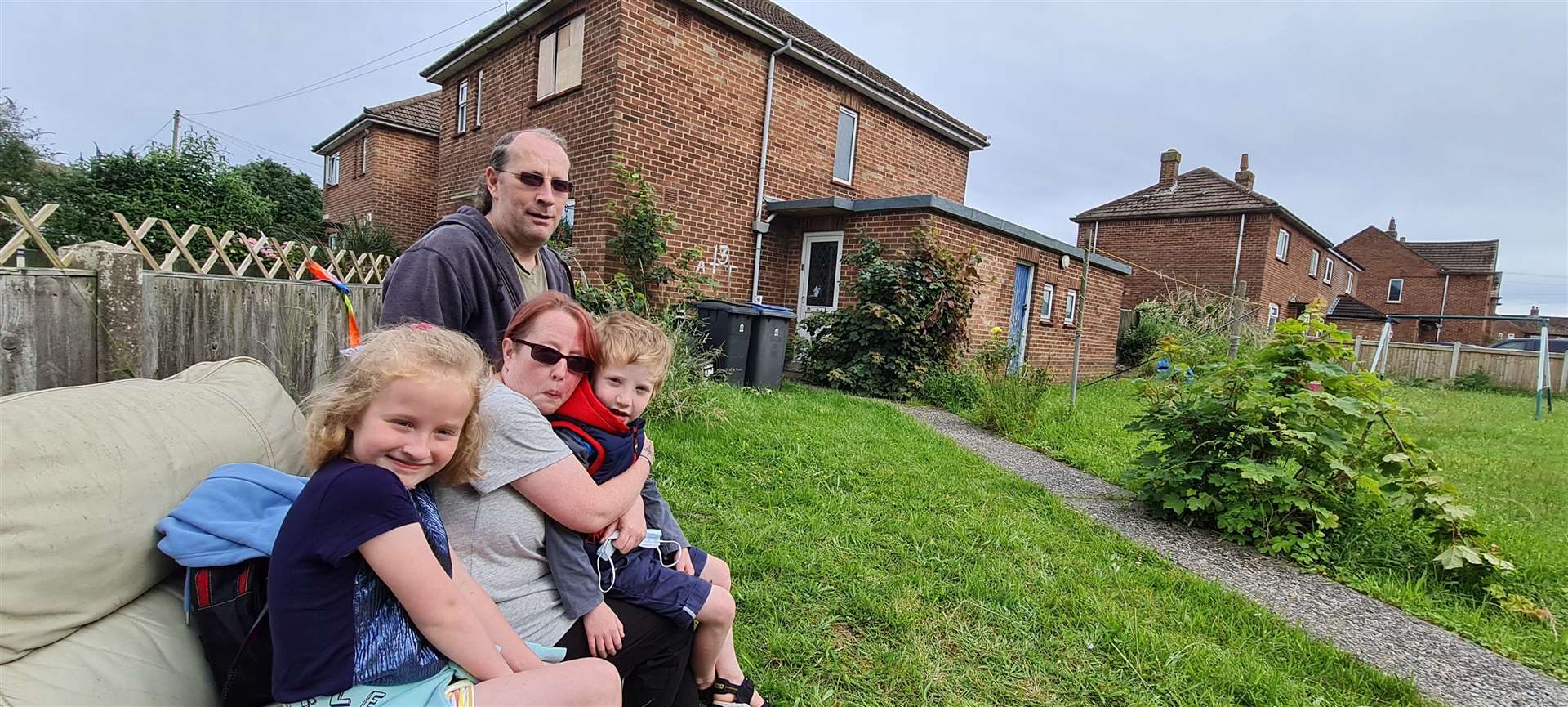 Mark Ross and Emma Baker with children Amelia and Logan outside their fire damaged flat
